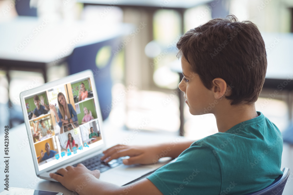 Side view of caucasian boy learning from woman teaching online over video call on laptop at home Side view of caucasian boy learning from woman teaching online over video call on laptop at home