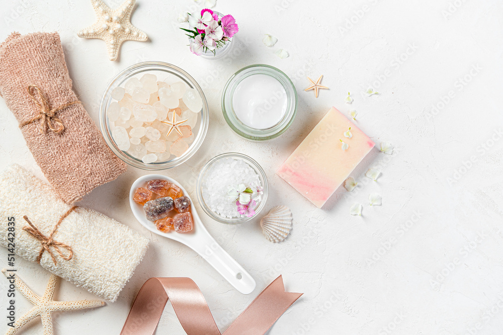 A set of cosmetics for spa care on a light gray background. Top view, copy space. A set of cosmetics for spa care on a light gray background. Top view, copy space.
