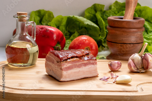 piece of smoked bacon on a wooden board, ingredient, gastronomy, preparation food
