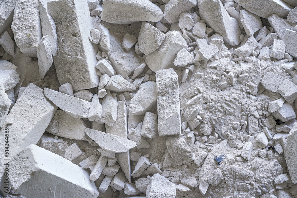 Construction waste debris - remains of white aac - autoclaved aerated concrete brick blocks, closeup detail