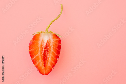 Close-up of strawberry slice with form as female vagina, creativity concept picture photo