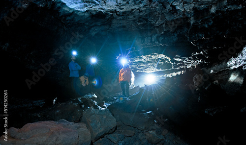 group of scientists exploring the Leidarendi lava cave in Iceland photo