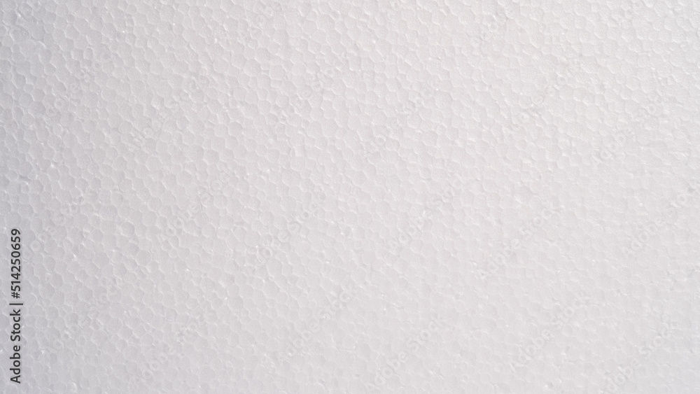 White foam sheet top view. Small and large clear foam beads, polystyrene sheet surface in closeup, close-up seamless background White foam sheet top view. Small and large clear foam beads, polystyrene sheet surface in closeup, close-up seamless background
