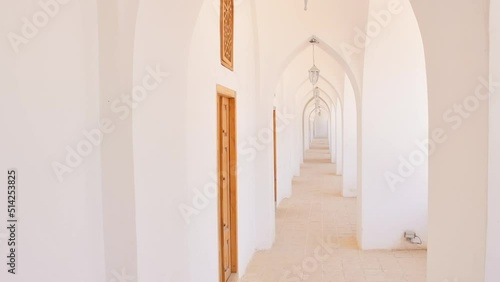 White interior with beautiful arches of old islamic school in city center of Esfahan photo