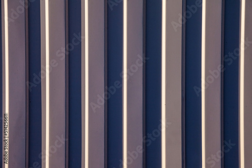 Close-up background vertical lines full frame. Gray steel wall abstract textured