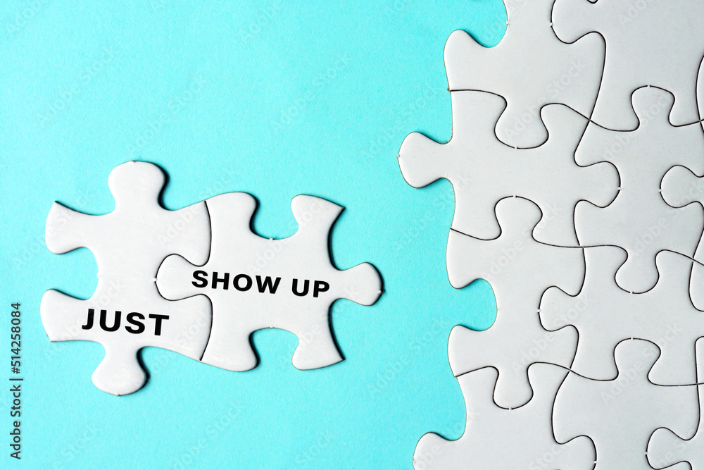 Fototapeta premium Just show up words on two pieces of white jigsaw puzzle on blue background.