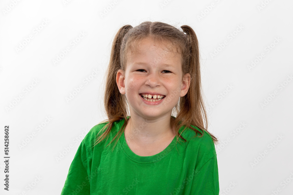 Smiling little girl in green t-shirt over white background Smiling little girl in green t-shirt over white background