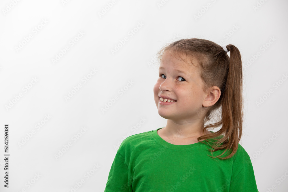 Smiling little girl in green t-shirt over white background Smiling little girl in green t-shirt over white background