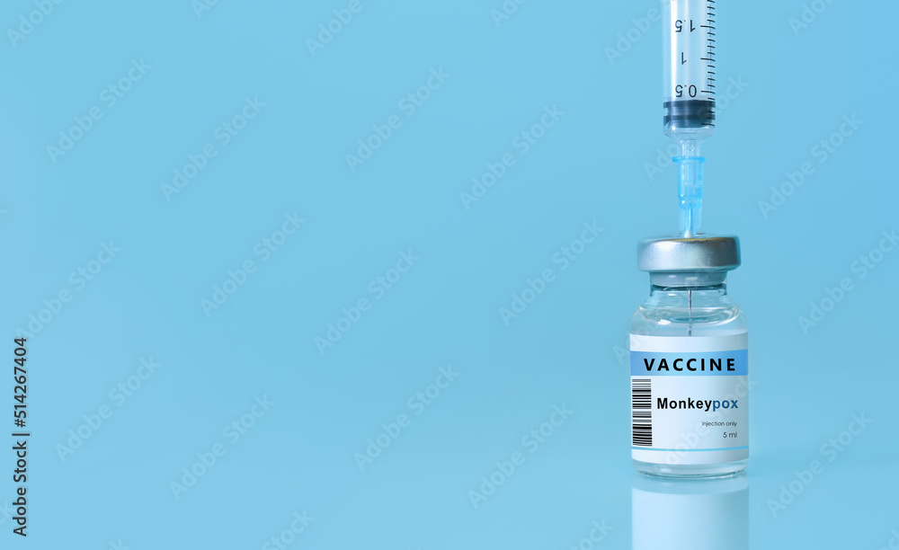 Vaccine Monkeypox and Smallpox vial with a syringe on a blue background.The concept of medicine, healthcare and science.Copy space for text. Banner Vaccine Monkeypox and Smallpox vial with a syringe on a blue background.The concept of medicine, healthcare and science.Copy space for text. Banner