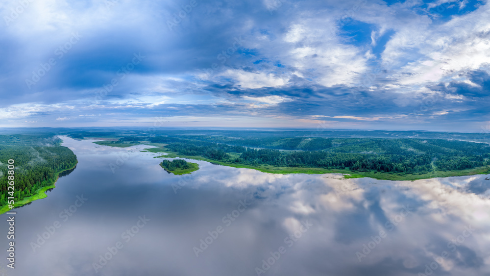 Big lake and island with green shores with morning fog in dawn, aerial landscape. Recreation concept. Aerial view
