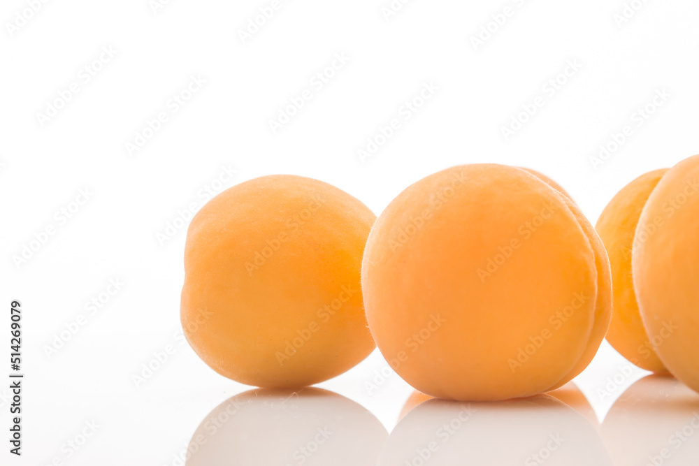 Yellow ripe apricots on a white background Yellow ripe apricots on a white background