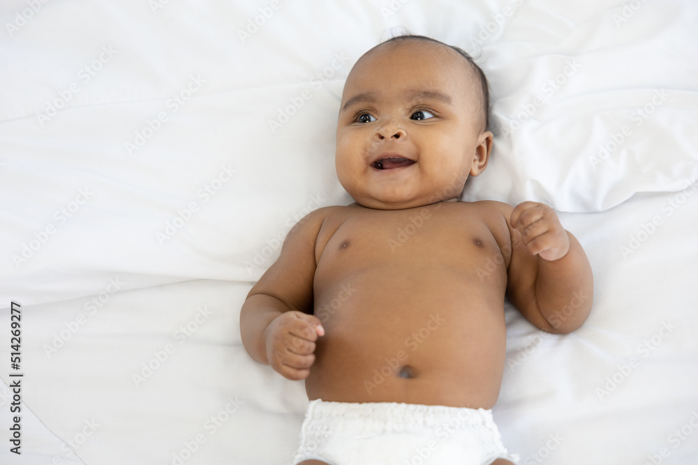 cute African baby lying on bed and smiling at home cute African baby lying on bed and smiling at home
