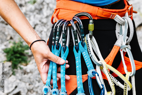 Faceless mountaineer holding climbing equipment in forest photo