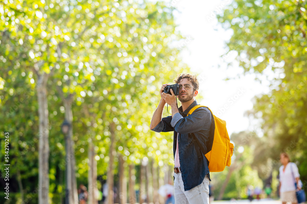 Young man taking photos in Madrid with an analog camera. Young man taking photos in Madrid with an analog camera.