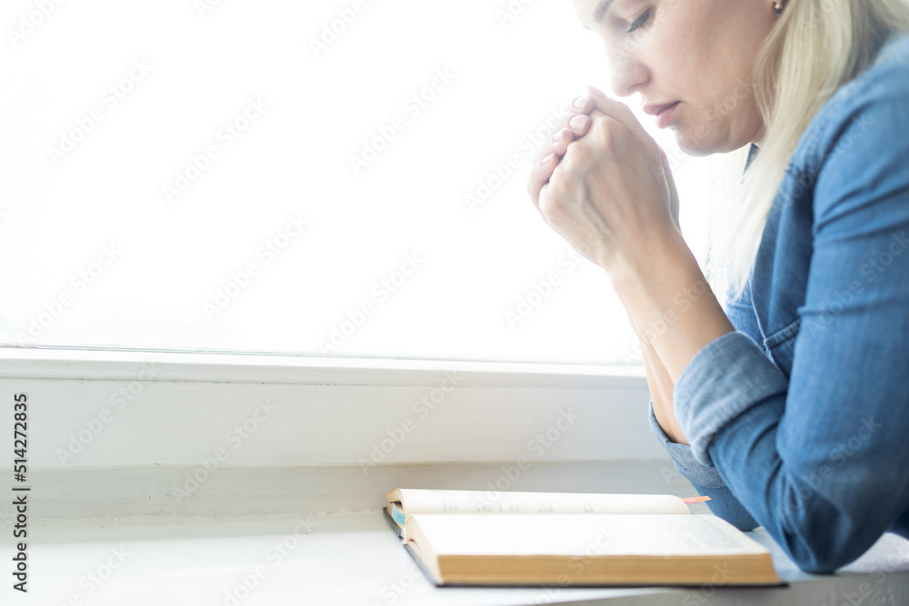 Christian life crisis prayer to god. Woman Pray for god blessing to wishing have a better life. woman hands praying to god with the bible. begging for forgiveness and believe in goodness