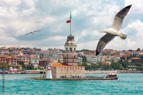 Seagulls flying near the historical Maiden's Tower I Kiz Kulesi symbol of Istanbul located in Uskudar, Salacak. Istanbul most popular tourism destination of Turkey. Travel Turkey concept.
 