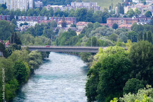 Aerial view over Aare River at City of Bern with bridge in the background on a blue cloudy summer day. Photo taken June 16th, 2022, Gurten, Switzerland.