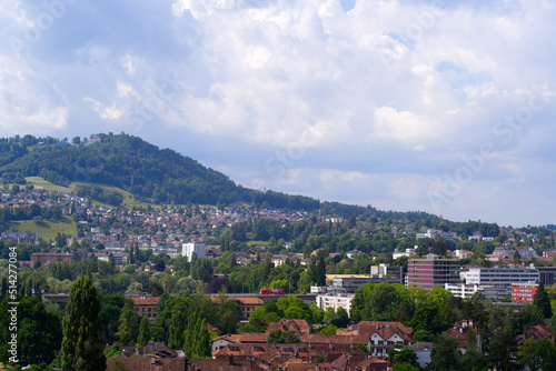 Scenic view of City of Bern with local mountain Gurten in the background on a blue cloudy summer day. Photo taken June 16th, 2022, Bern, Switzerland.