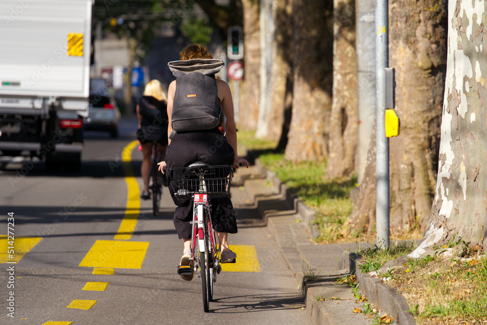 Fototapeta premium Cyclists on bicycle lane at City of Bern on a sunny summer morning. Photo taken June 16th, 2022, Bern, Switzerland.