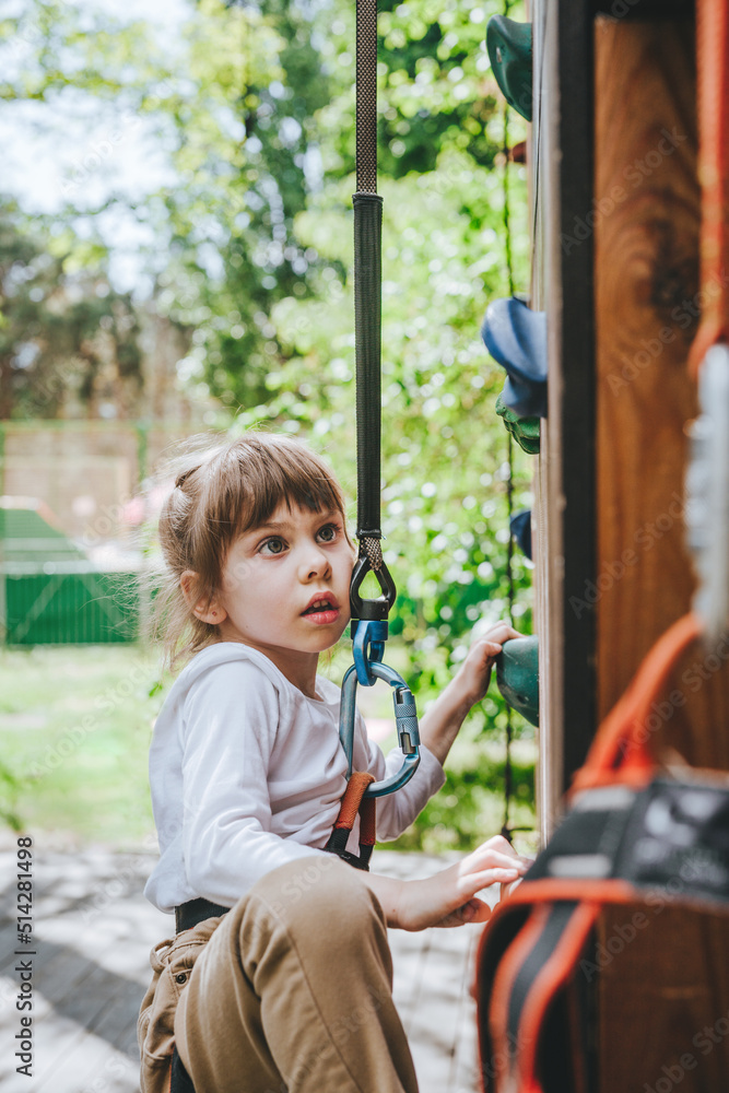 Little girl preschooler climbing on the stand Little girl preschooler climbing on the stand