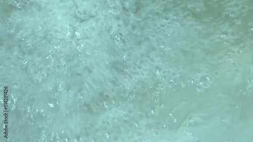 Air bubbles in the clear blue water in the pool. Soft focus on the background of boiling water. Concept relaxation pool, spa hydrotherapy. High quality FullHD footage
