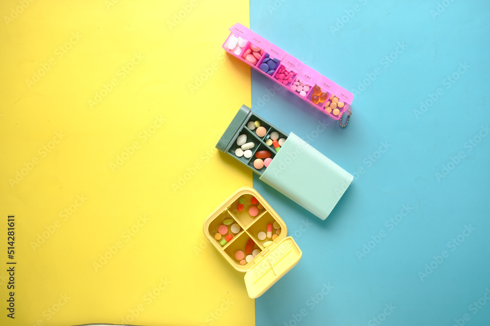 top view of may medical pills in a pill box on table top view of may medical pills in a pill box on table