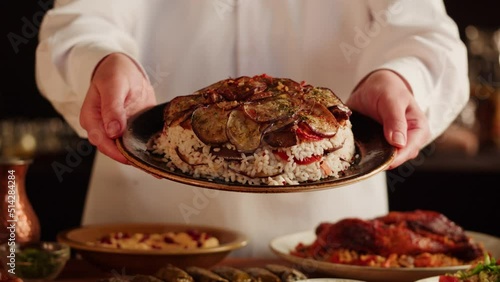 Maqluba dish close-up, rice and vegetables, Arabian national traditional food. Muslim family dinner, Ramadan, iftar. Arab cuisine delivery. Religious holiday, holy month. photo