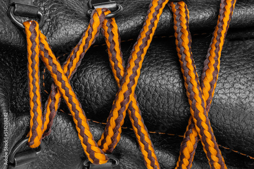 Shoe lacing close up. Shoelaces crossing. Orange Shoelaces.