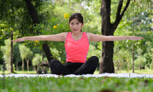 Asian woman doing exercise in park.