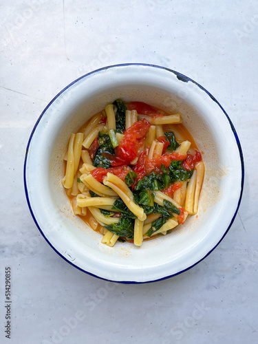 Pasta with tomato and spinach. Vegetarian healthy meal