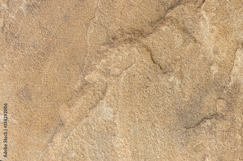 Stone background of sand color with real patterns of spots and scratches close-up. Stone real wall. Stone background of sand color with real patterns of spots and scratches close-up. Stone real wall.