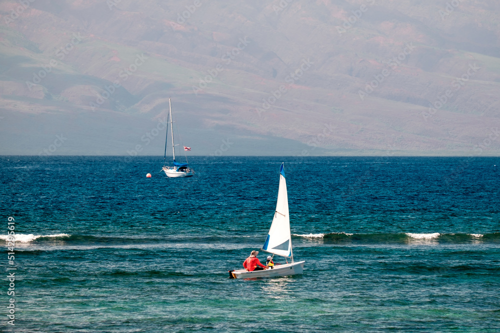 Obraz premium a father and son sailing together off the coast of Hawaii