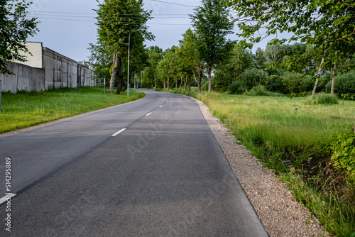 new winding asphalt road near abandoned industrial district in Latvia, Jelgava town 