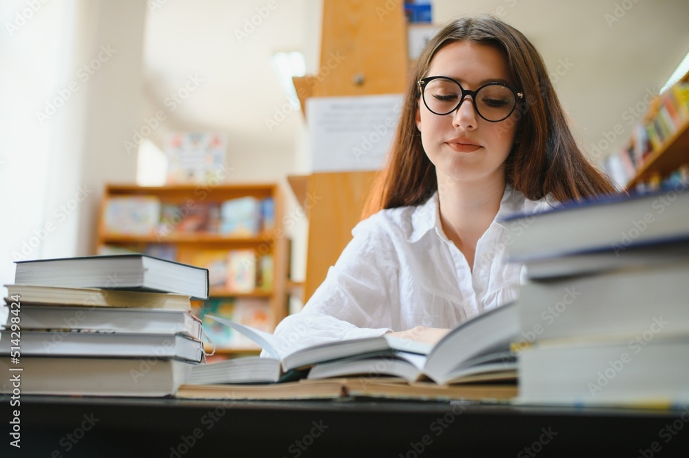 Portrait of a student girl studying at library Portrait of a student girl studying at library