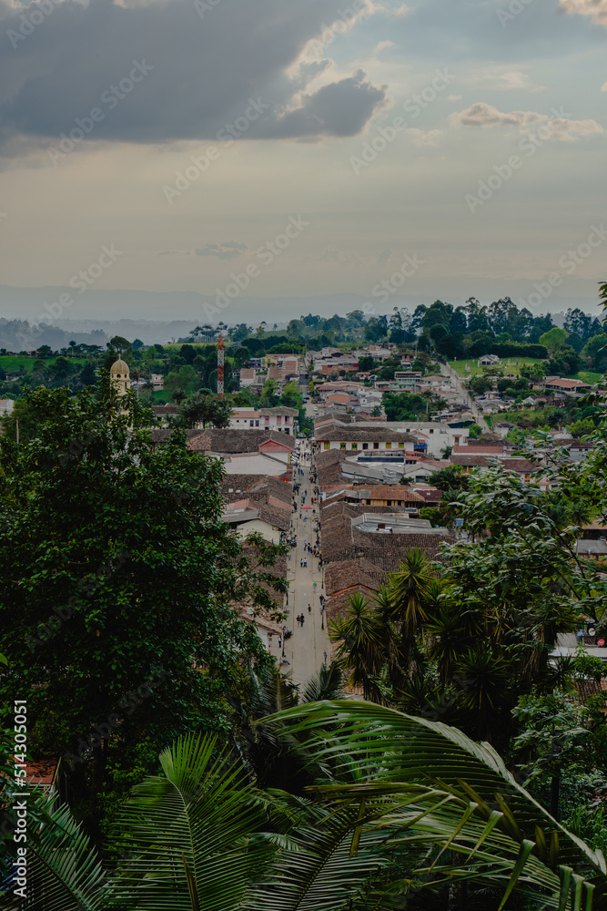 Salento quindio, colombia in aerial view among the tropical trees, tourist village. vertical photo