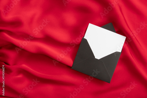 open envelope on red fabric