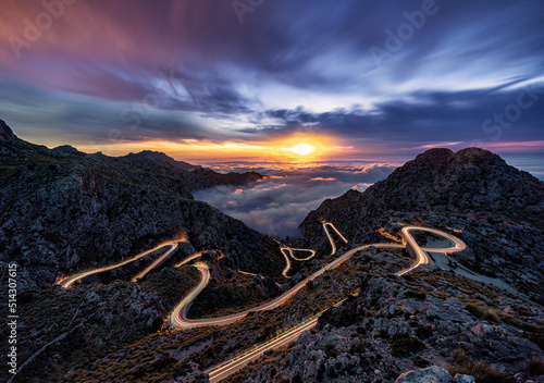 Long exposure of spectacular hair pin road with light trails on Mallorca, Spain at sunset