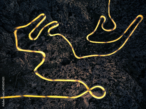 Top down aerial shot with long exposure of spectacular hair pin road with light trails on Mallorca, Spain