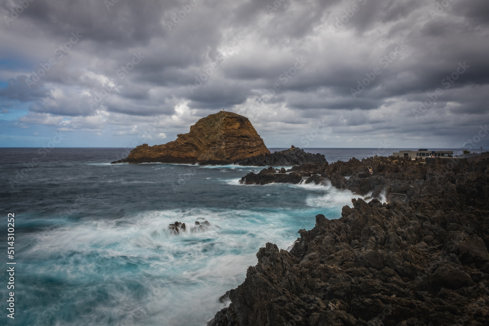 Beautiful nature landscape with Atlantic Ocean and lava rock natural swimming pools in Porto Moniz, Madeira, Portugal. Long exposure picture, october 2021.