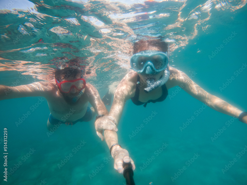 couple snorkeling in clear blue water