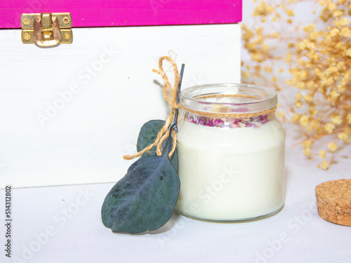 scented candles in glass jar with decorative elements