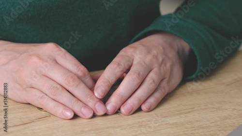 female hands calculating counting money coins euro cents on wooden table. close-up caucasian woman fingers grabbing sorting eurocents. concept poverty, bankrupt, debt, savings. salary wedges problem photo