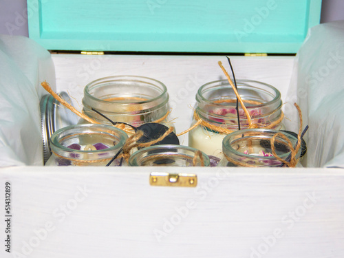 scented candles in glass jar with decorative elements
