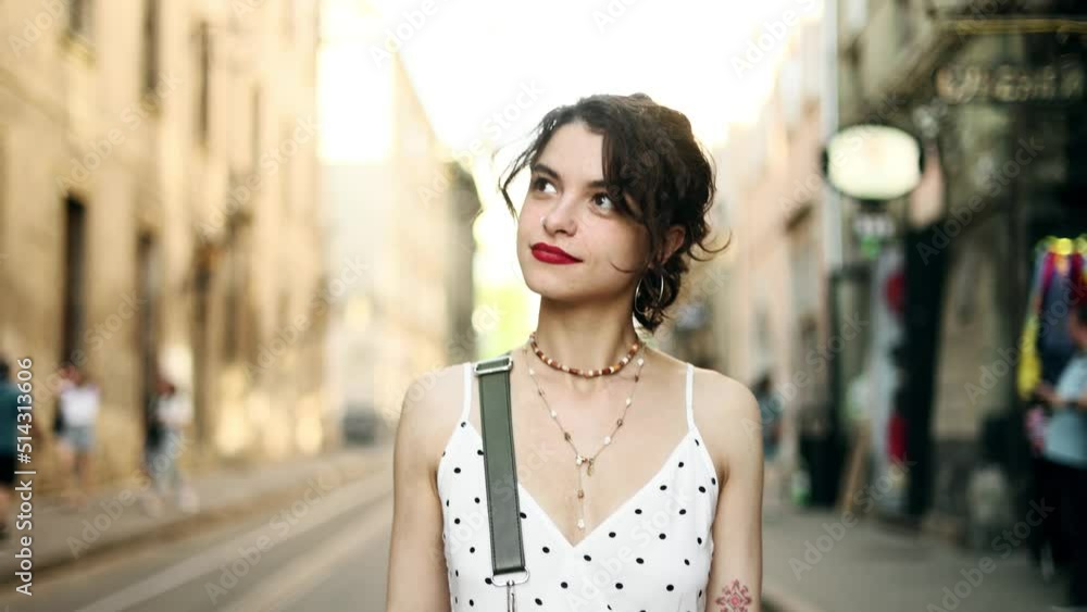 Portrait of young brunette woman walking down the street and looking ahead. Attractive woman in the city centre. Portrait of young brunette woman walking down the street and looking ahead. Attractive woman in the city centre.