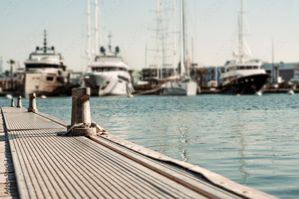 Detail photo of a maritime dock with yachts and boats in the background, analogic photo