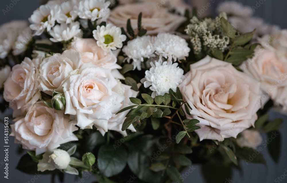 A beautiful bouquet of beige, cream roses and white chrysanthemums. Background floral image of pastel colors. Natural, environmentally friendly natural background. A copy of the place for the text. A beautiful bouquet of beige, cream roses and white chrysanthemums. Background floral image of pastel colors. Natural, environmentally friendly natural background. A copy of the place for the text.