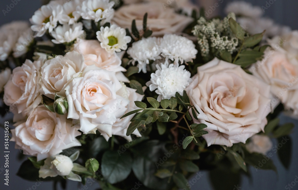 A beautiful bouquet of beige, cream roses and white chrysanthemums. Background floral image of pastel colors. Natural, environmentally friendly natural background. A copy of the place for the text.