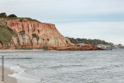 An ocean landscape scene with a rocky cliff