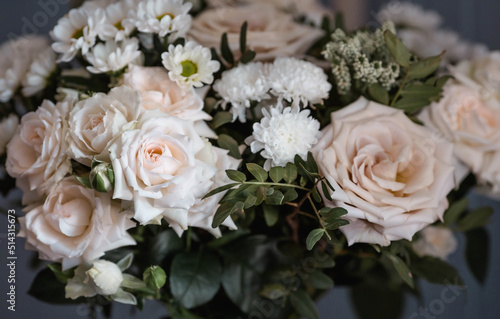 A beautiful bouquet of beige, cream roses and white chrysanthemums. Background floral image of pastel colors. Natural, environmentally friendly natural background. A copy of the place for the text. © Юлия Клюева