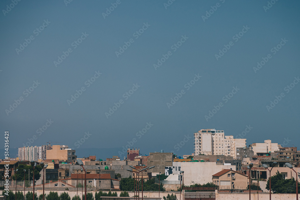 Residental buildings in the city of Oran, Algeria with some large skyscrapers dominating the skyline on a sunny day. Residental buildings in the city of Oran, Algeria with some large skyscrapers dominating the skyline on a sunny day.